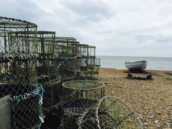 Lobster trap on shore against sky