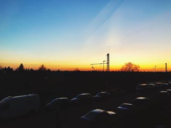 Silhouette of city against clear sky during sunset