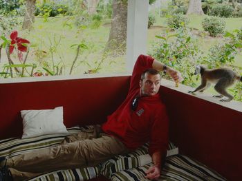 Portrait of man sitting on bed