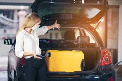 Yellow suitcases of women in the trunk of a car. people's lifestyles and transportation concepts.