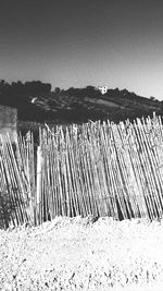 Wooden posts on beach against clear sky