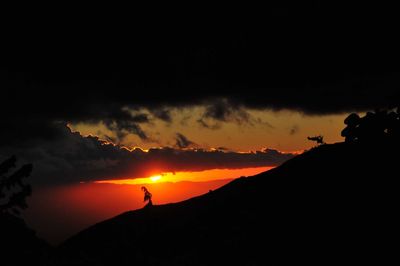 Scenic view of silhouette mountains against sky during sunset