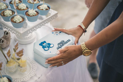 Midsection of woman having cake