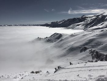 Scenic view of snow covered mountains against sky