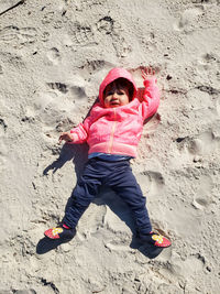 Full length of young woman standing at beach