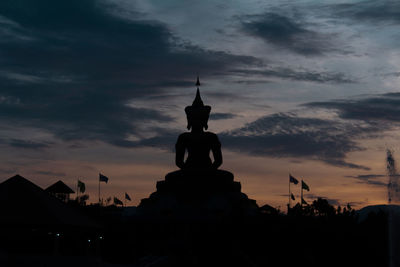 Silhouette of building against cloudy sky during sunset