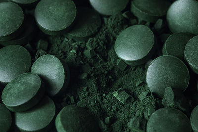 Spirulina powder and tablets algae. macro close up.