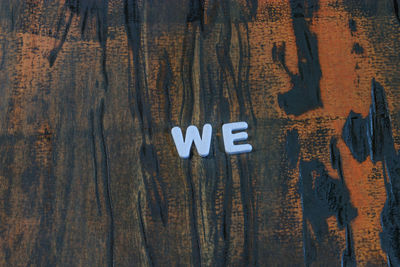 Close-up of text on wooden table