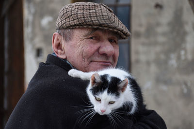 Portrait of a smiling man with cat