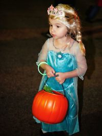 Cute girl wearing princess costume during halloween