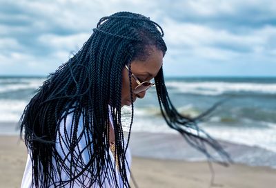 Woman with braided hair looking at sea 