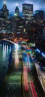 High angle view of illuminated street amidst buildings at night