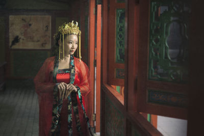 Woman in traditional clothing standing at temple