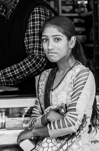 Portrait of young woman sitting outdoors