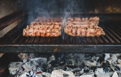 High angle view of meat on barbecue grill