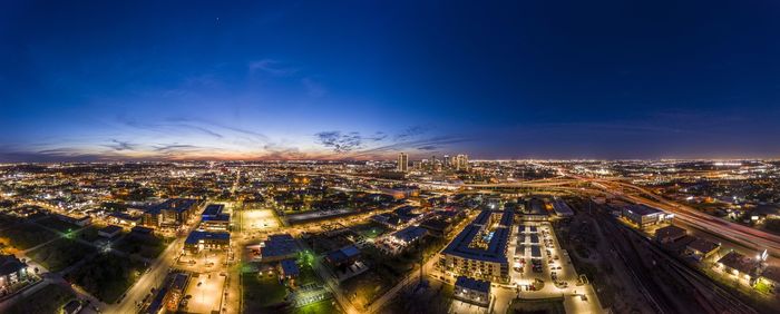 High angle view of illuminated cityscape against sky at night