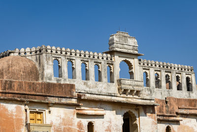 Low angle view of historical building against clear blue sky