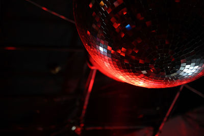 Low angle view of illuminated lamp hanging on ceiling