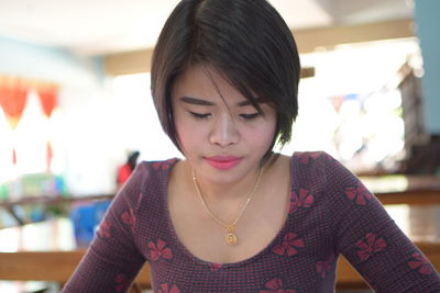 Close-up of young woman looking down