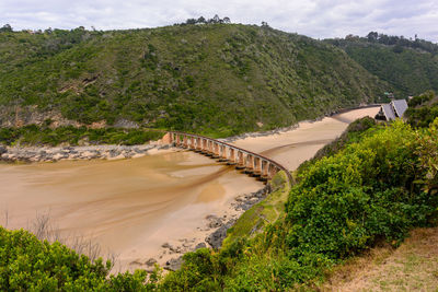 Estuary of kaimaans river,garden route,south africa with railway bridge, surrounding hills,