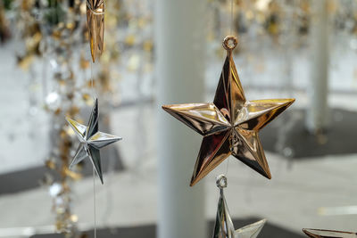 Close-up of christmas decorations hanging on paper