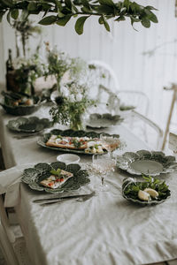 Plates and floral decorations on dining table