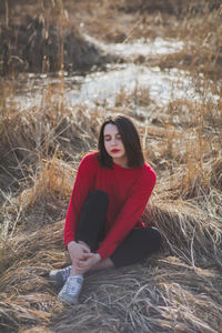 Portrait of young woman sitting outdoors