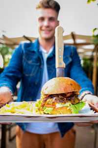 Midsection of man holding food