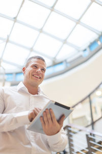 Portrait of a smiling young man using mobile phone