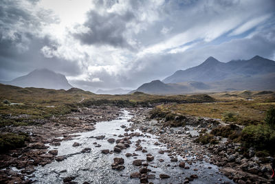 Scenic view of mountains against cloudy sky