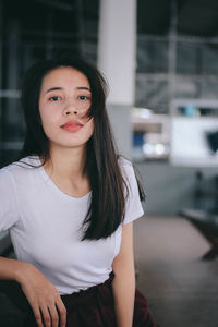 Portrait of teenage girl sitting outdoors