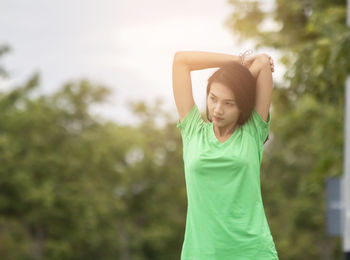 Portrait of a smiling young woman standing outdoors