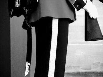 Close-up of child standing on metal grate