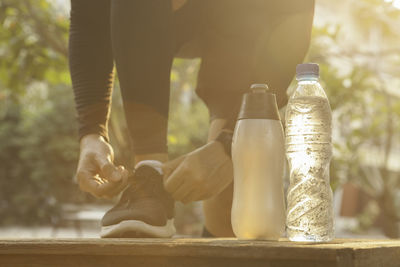 Low section of man by bottle