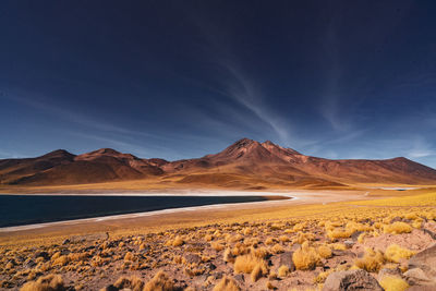 Scenic view of salt flats against clear blue sky