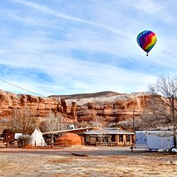 Hot air balloon flying over water against sky