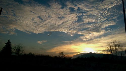 Scenic view of landscape against sky at sunset