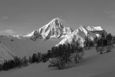 Scenic view of snowcapped mountains against sky