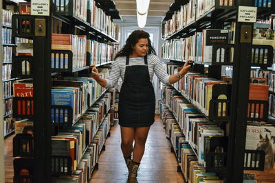 Full length of woman standing on book