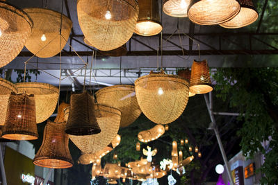 Low angle view of illuminated lanterns hanging at store