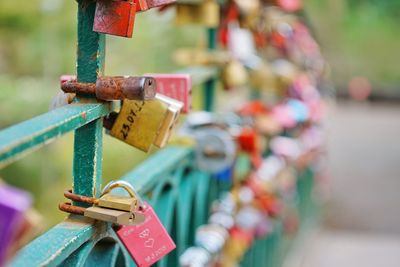 Close-up of padlocks hanging on railing