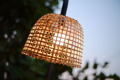 Low angle view of illuminated lamp against sky