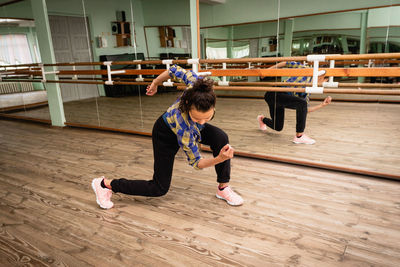 Pretty young woman vlogger showing dance move.a young woman is engaged in contemporary dance alone 