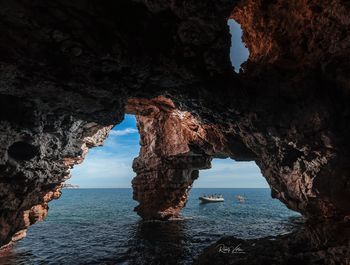 Scenic view of sea seen through cave