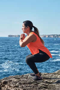 Latin woman, middle-aged, wearing sportswear, training, doing physical exercises,