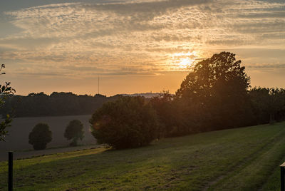 Scenic view of field against sky during sunset