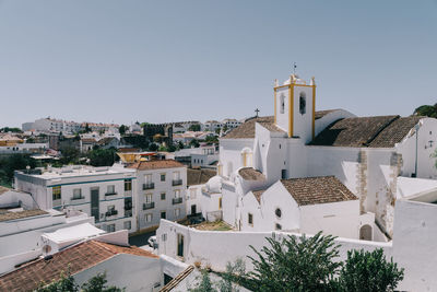 Buildings in city against clear sky