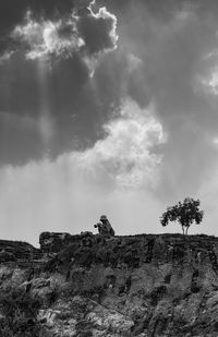 Low angle view of cliff against sky