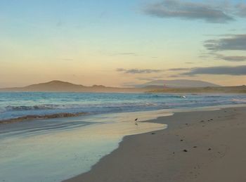 Scenic view of beach against sky during sunset