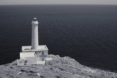 High angle view of lighthouse by sea against sky